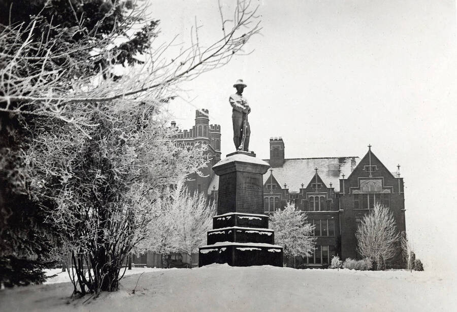 1924 photograph of Spanish American War Memorial. Administration Building in background, snow covering scene. [PG1_099-04]