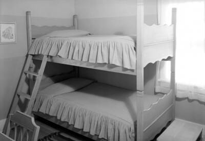 1945 photograph of the Home Management House. A bedroom with bunk beds.