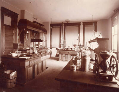 1926 photograph of Mines Building. Laboratory equipment in foreground.