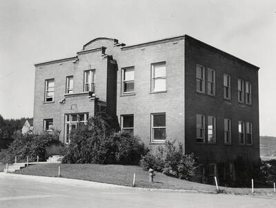 1936 photograph of Dairy Science Building. Fire hydrant in foreground.