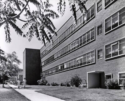 1955 photograph of Agricultural Science Building. Students in foreground. Donor: Publications Dept..