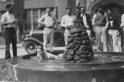 1920 photograph of a student in the Administration Building Fountain.