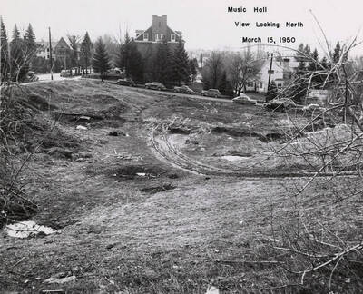 March 15, 1950 photograph of the Music Building under construction. Kappa Sigma house in background.