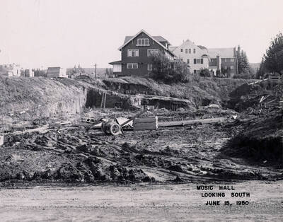 June 15, 1950 photograph of the Music Building under construction. Houses in the background.