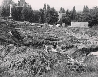 June 15, 1950 photograph of the Music Building under construction. Kappa Sigma house in the background.