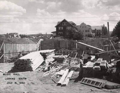 July 15, 1950 photograph of the Music Building under construction. Houses in the background.