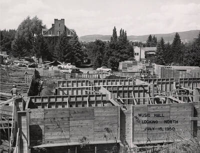 July 15, 1950 photograph of the Music Building under construction. Kappa Sigma house in the background.