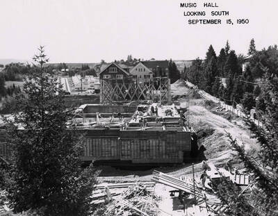 September 15, 1950 photograph of the Music Building under construction. Houses in the background.