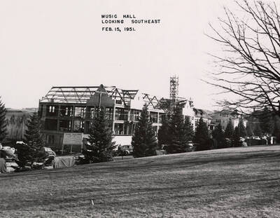 February 15, 1951 photograph of the Music Building under construction. Automobiles in foreground.