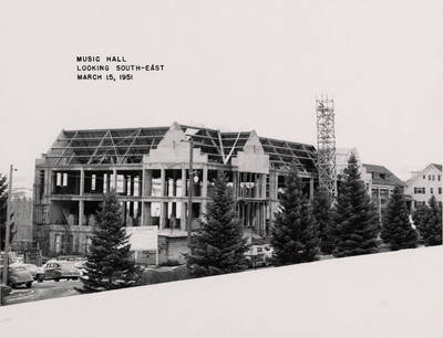 March 15, 1951 photograph of the Music Building under construction. Automobiles in the foreground.