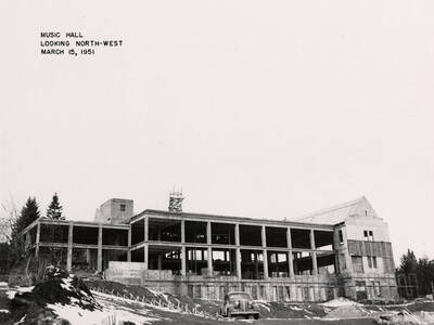 March 15. 1951 photograph of the Music Building under construction. Automobile in the foreground.
