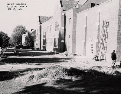 September 15, 1951 photograph of the Music Building under construction. Students in the foreground.