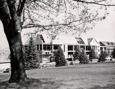 1951 photograph of Music Building under construction. Automobiles in the foreground.