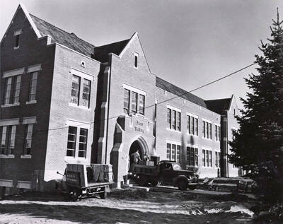 1951 photograph of Music Building under construction. Construction workers in the foreground.