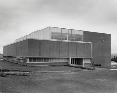 1957 photograph of the Library. Student in foreground.