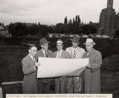May 26, 1956 photograph of the Library under construction. Left to right: Lee Zimmerman, Elvon Hampton, Jack McBride, Harold Snow, Donald R.Theophilus look over architect's plans.