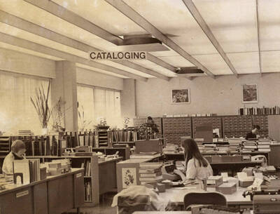 1978 photograph of the Library. Left to right: Henrietta Pew, Karen Eckert, Judith Faulkner in the Technical Services department with card catalog in background.