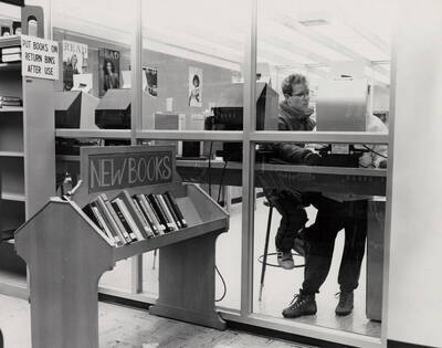 1988 photograph of the Library. Students work on computers in the catalog area.