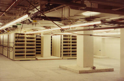 December 15, 1988 photograph of the Library. Compact shelving in basement. Donor: Monte Steiger.
