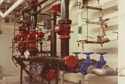 December 15, 1988 photograph of the Library. Pipes in basement. Donor: Monte Steiger.