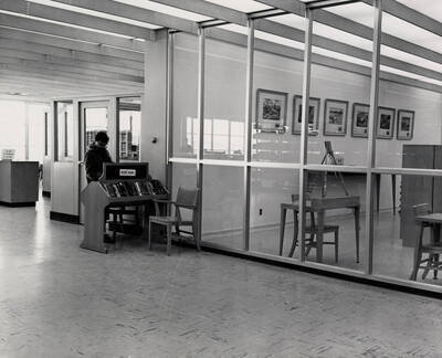 1957 photograph of the Library. A student browses new books on the left.