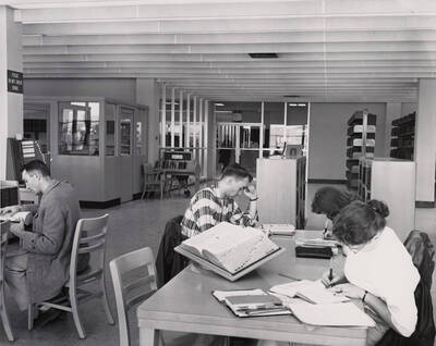 1957 photograph of the Library. Several students study in the foreground.
