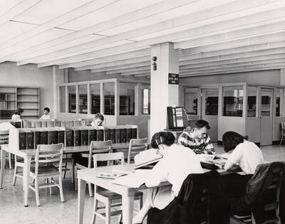 1957 photograph of the Library. Several students study in the foreground.