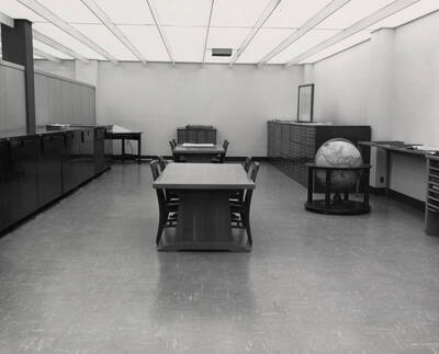 1957 photograph of the Library. Map room with tables in center.