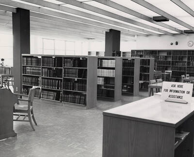 1957 photograph of the Library. Reference area with stacks in foreground.