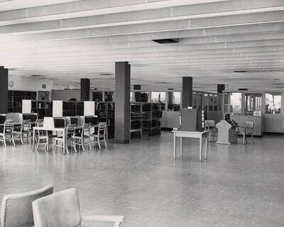 1957 photograph of the Library. Reference area with stacks to the left.
