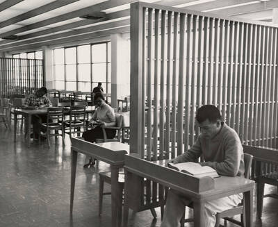 1957 photograph of the Library. Students studying at tables.