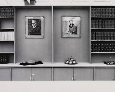 1963 photograph of the Library. Portraits of Mr. and Mrs. Jerome Day in the Special Collections department.
