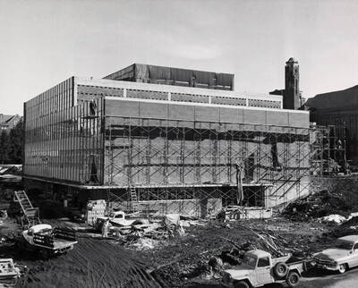 1957 photograph of the Library under construction. Automobiles in foreground. Donor: Publications Dept.
