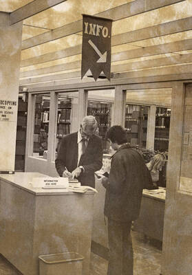 1977 photograph of the Library. Rod Hardies helps a student.