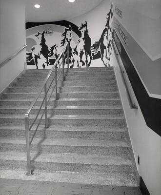 October 1, 1982 photograph of the Library. A mural of horses in a stairwell.