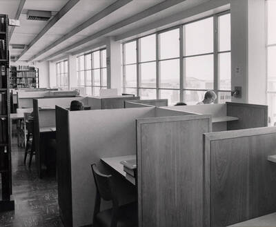 October 1, 1982 photograph of the Library. Students study at desks with Law Building visible in background.