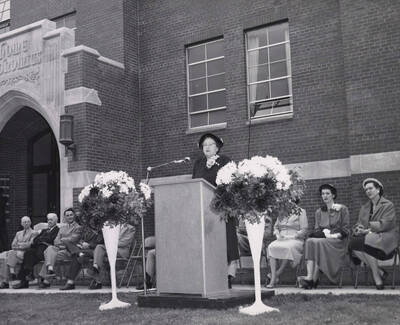1953 photograph of the Home Economics Building dedication ceremony. Mrs. Marguerite Campbell at lectern.