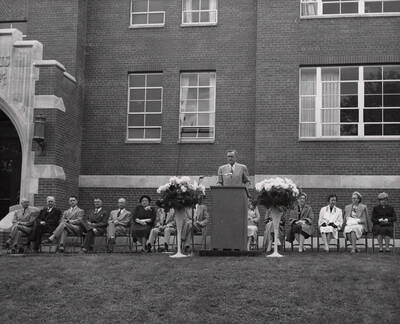 1953 photograph of the Home Economics Building dedication ceremony. President Buchanan at lectern.