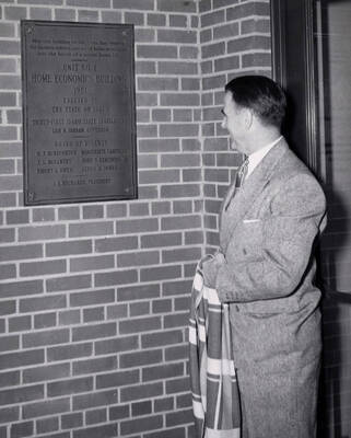 1953 photograph of the Home Economics Building dedication ceremony. Regent J. L. McCarthy at dedicatory plaque.