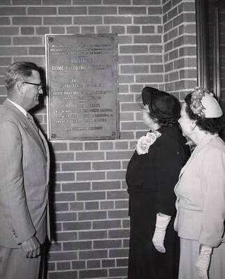 1953 photograph of the Home Economics Building dedication ceremony. Left to right: President Buchanan, Marguerite Campbell, Margaret Ritchie at dedicatory plaque.