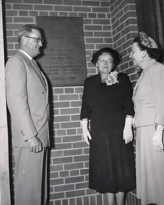 1953 photograph of the Home Economics Building dedication ceremony. Left to right: President Buchanan, Marguerite Campbell, Margaret Ritchie next to dedicatory plaque.