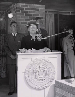 1953 photograph of the Ethel Steel House dedication ceremony. Mrs. Ethel Steel at lectern.