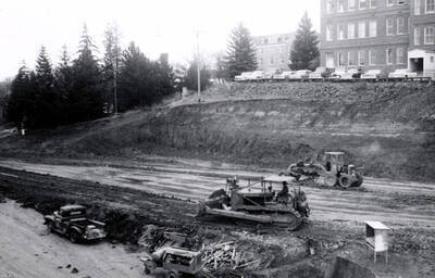1960 photograph of the Mines Building under construction. Construction workers on equipment in foreground. Donor: College of Mines.