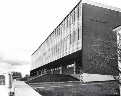 1962 photograph of the Mines Building. A student walks away from the building.