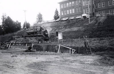 1960 photograph of the Mines Building under construction. Construction workers on equipment in foreground. Donor: College of Mines.
