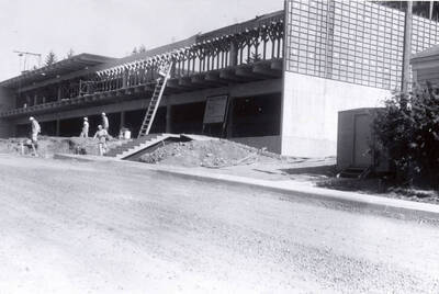 1960 photograph of the Mines Building under construction. Construction workers to the left. Donor: College of Mines.