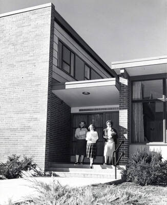 1954 photograph of the Permeal J French House. Students leave the building in center. Donor: Publications Dept.