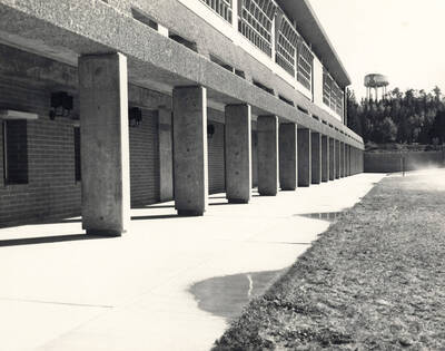 1965 photograph of University Classroom Center. Water tower in background.