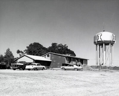 1966 photograph of President's Residence under construction. Automobiles in foreground. Donor: Publications Dept..