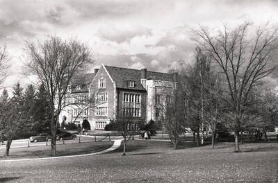 1956 photograph of Life Sciences Building. Trees in foreground, students approach the building. Donor: Publications Dept.